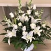 All white arrangement with white lilies and rose mix 