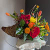 Beautiful arrangement of fresh flowers displayed inside a cornocopia 