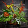 A rich brown wicker basket filled with evergreens, magnolia foliage,pine cones and