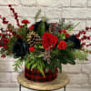 A fun take on holiday flowers featuring ultra specialty Black roses along