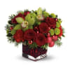 A cube arrangement with a mixture of Christmas Greens, Roses, and Cymbidium