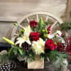 This fragrant arrangement combines a lush array of Forest Evergreens, Red Roses