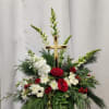 A heartfelt holiday remembrance featuring vibrant red and white flowers, artfully arranged