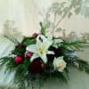 Deck the halls with our stunning Christmas floral arrangement, perfect for adding