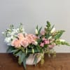 A graceful arrangement of soft colors in a crescent-shaped ceramic vase (8&quot;