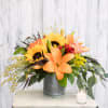 Overflowing with autumn favorites including lilies, eucalyptus, roses and sunflowers, this rustic