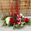 Double candle centerpiece with a mixture of fresh wintergreens, roses and accents.

Deluxe: