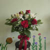 A stunning arrangement of deep red roses, white alstromeria, delicate white lilies