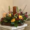 A lovely and unique fall centerpiece arranged in a mango wood tray
