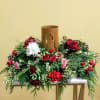 Add blustery cheer to any holiday table with this coniferous centerpiece studded