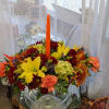 Fall colored flowers with candles for a lively and festive centerpiece for