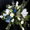 Pure white, deep blue, elegant winter greenery and accents. This centerpiece is