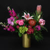 Exotic blooms with a touch of garden love. This lush arrangement is