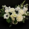 This stunning white arrangement will speak volumes of sympathy and class. With