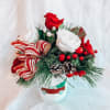 Variety of Christmas Greenery with roses, carnations, red berries and pinecones in