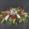 Simple, elegant, and colorful. Our lilies and carnations casket spray is packed