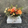 Orange bi-color roses, a mix of chrysanthemums, spray roses, berries, seeded eucalyptus