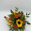 This adorable small cornucopia bursts with bright blooms and cheerful fall colors