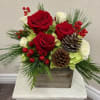 Red and white flowers with Christmas Greens in a wooden square box
