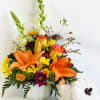 White ceramic pumpkin bouquet filled with orange asiatic lilies, daisies, mums, roses