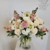 A taller version of our muted elegance. Arrangement includes roses, spray roses
