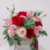 an array of red pink and white flowers with a succulent in