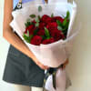 Dozen Red Roses with greenery and decorative wrapping paper. All bouquets come