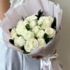 White Roses with greenery and decorative wrapping paper. All bouquets come without