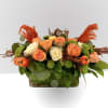 Celebrate Thanksgiving with our Harvest Glow Centerpiece: featuring peach and cream roses