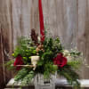A festive holiday design filled with evergreens, pinecones and accented with red
