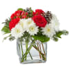 A delicate balance of red and white florals accented with seasonal greens