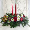 Fresh Christmas Greens with two Candles. Decorated with fresh flowers, pinecones and