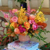 Flowers: orange roses, pink tulips, yellow spotted mokara orchids, astilbe pink, orange