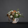 This keepsake gingerbread mug is filled with spray roses, blush delphinium, and