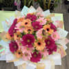 A 50-count, full gerbera arrangement set in oasis and wrapped for a