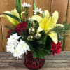 Find some holiday cheer in this colorful holiday arrangement, with yellow lilies