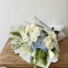This bouquet features white and soft blue colors. 