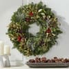 Our fresh green wreath has the perfect blend of holiday greenery, berries