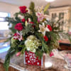 This Christmas combination of ever greens, lilies, roses and hydrangeas provides the