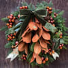 Wreath in fall tones. 30&quot; natural wreath with baubles, greens, and ribbon.