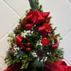 This fragrant holiday tree is adorned with ornaments and fresh flowers to