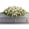 The purity of this all-white casket spray creates an aura of serenity