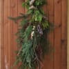 Instead of a classic wreath, go with a wintertime natural door swag