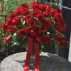 Spectacular three dozen long stem red roses arranged in a glassware. Classic