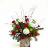 This is a festive holiday floral arrangement featuring a cheerful mix of