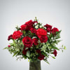 A striking mix of rich red blooms and fresh greenery. This design