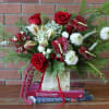 **Name:** &quot;Crimson Winter Elegance&quot;

**Description:**  
This stunning modern flower arrangement centers around