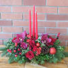 Beautiful burgundy orchids, red roses, pine cones, evergreens and lush fillers with