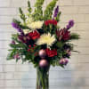 Get the holiday spirit with a red, purples fresh arrangement. 

