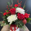 The arrangement is crafted in a festive, reindeer container -Interspersed with the